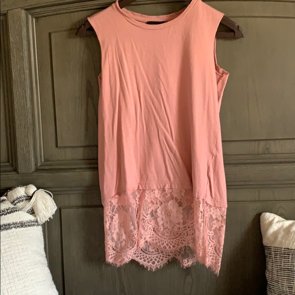 Pink sleeveless shirt with lacy accent on bottom